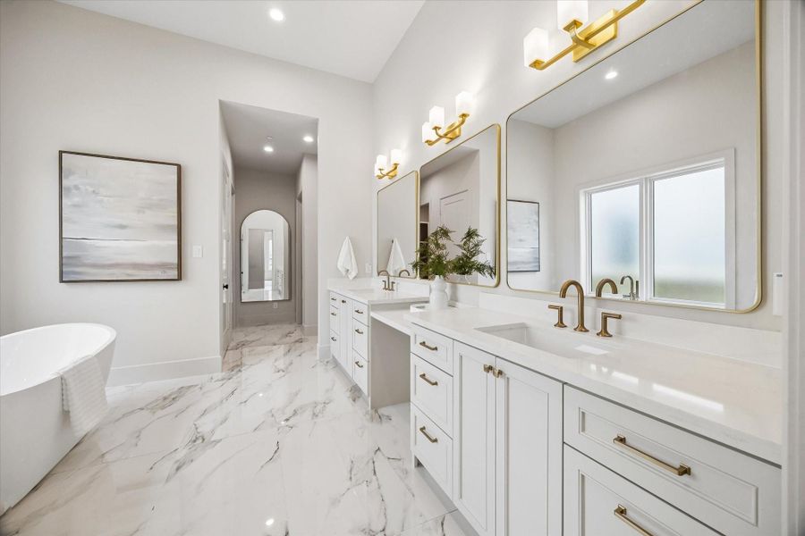 The first-floor primary bath features dual vanities with quartz counters, a freestanding tub, and a separate shower for a clean, spa-inspired retreat. The first-floor primary bath features dual vanities with quartz counters, a freestanding tub, and a separate shower for a clean, spa-inspired retreat.