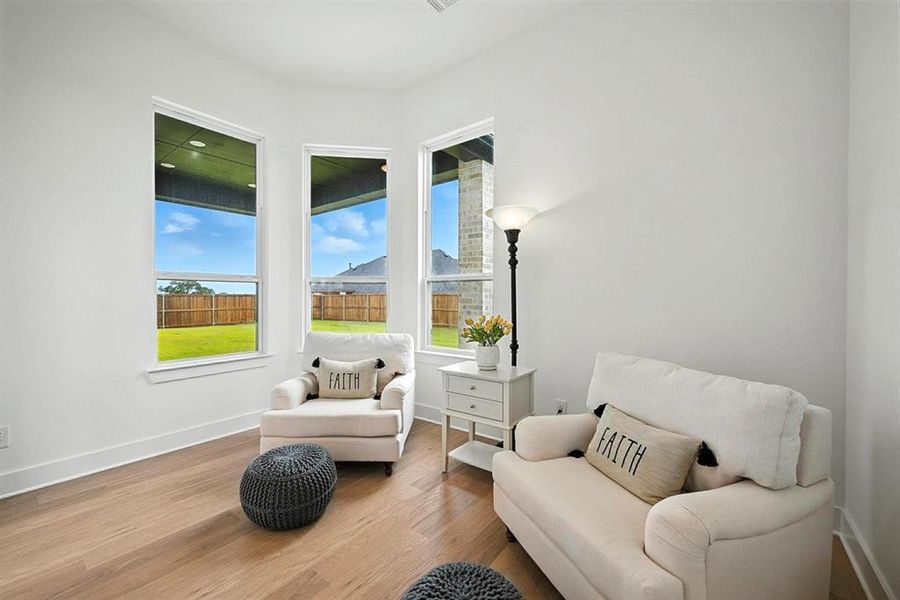 Living area with wood finished floors and baseboards