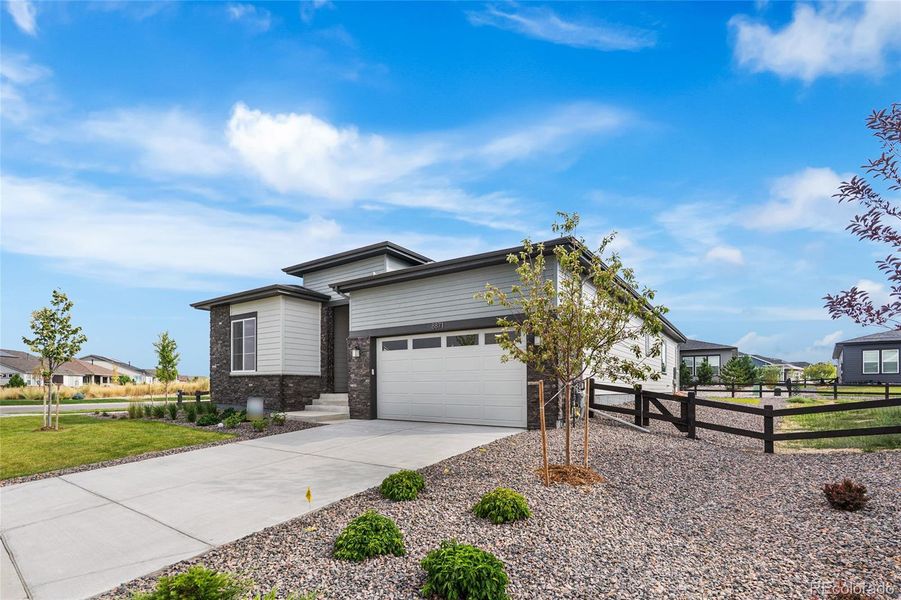 Front exterior of a new home in Hilltop at Inspiration, Aurora, CO, highlighting curb appeal (Image 21).