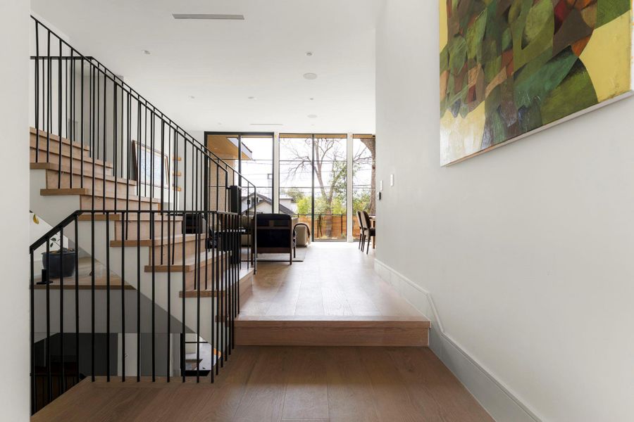 Hallway featuring light wood-style flooring and expansive windows