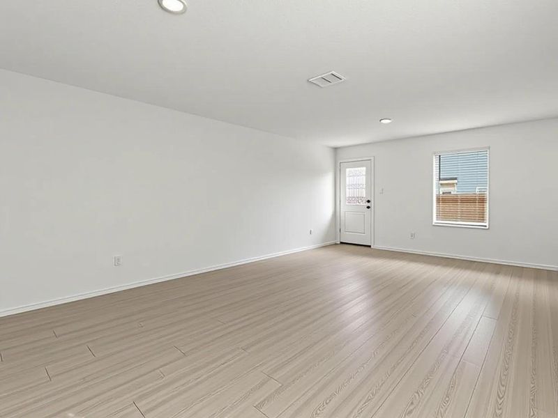 Photo has been enhanced with virtual modification.  Unfurnished room with light wood finished floors and recessed lighting