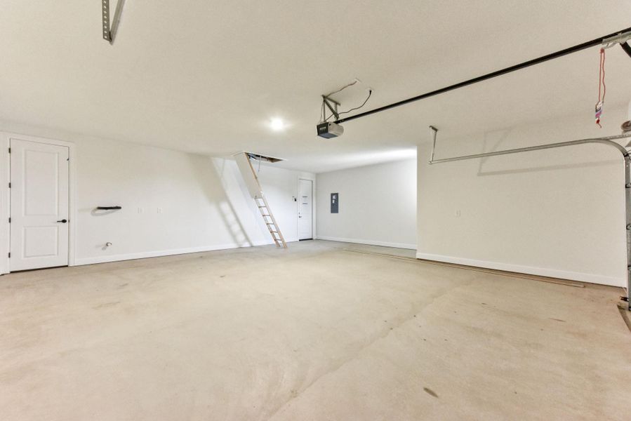 Garage featuring baseboards