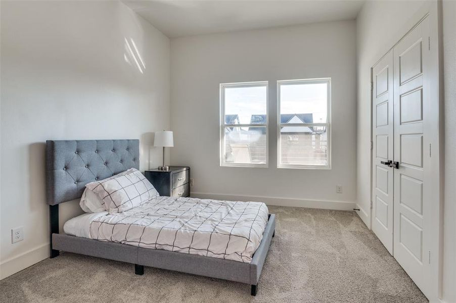 Bedroom with light colored carpet