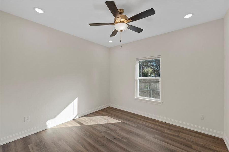 Spare room with dark wood-style flooring, recessed lighting, and a ceiling fan Spare room with dark wood-style flooring, recessed lighting, and a ceiling fan