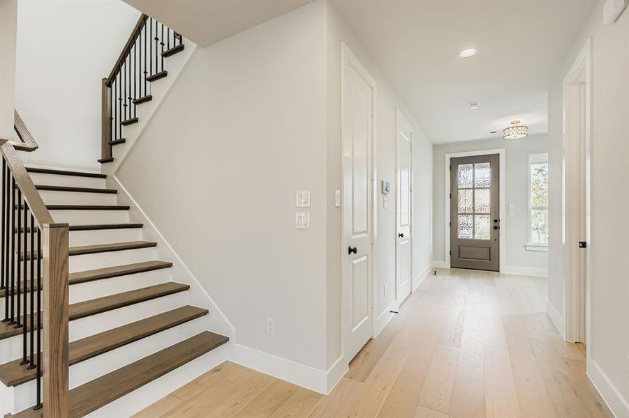 Foyer entrance featuring light wood-style flooring, stairs, and recessed lighting