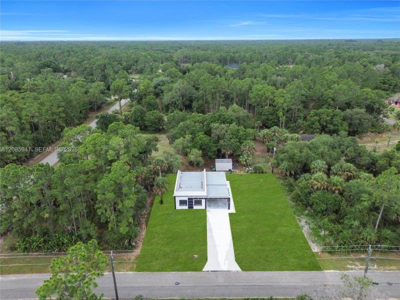 Front exterior of a new home in , Lehigh Acres, FL, highlighting curb appeal (Image 26). Front exterior of a new home in , Lehigh Acres, FL, highlighting curb appeal (Image 26).