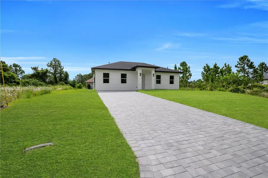 Front exterior of a new home in , Lehigh Acres, FL, highlighting curb appeal (Image 1). Front exterior of a new home in , Lehigh Acres, FL, highlighting curb appeal (Image 1).