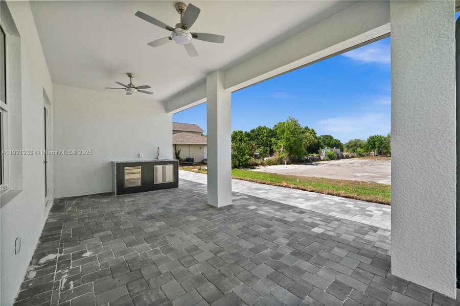 View of patio / terrace featuring ceiling fanand an outdoor kitchen View of patio / terrace featuring ceiling fanand an outdoor kitchen