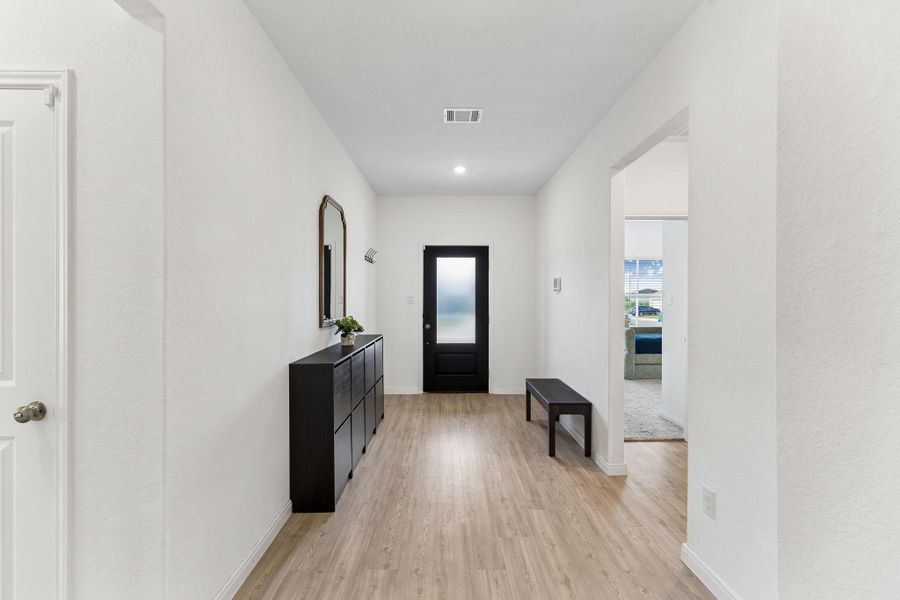 A welcoming entryway with durable LVP flooring and crisp white walls.