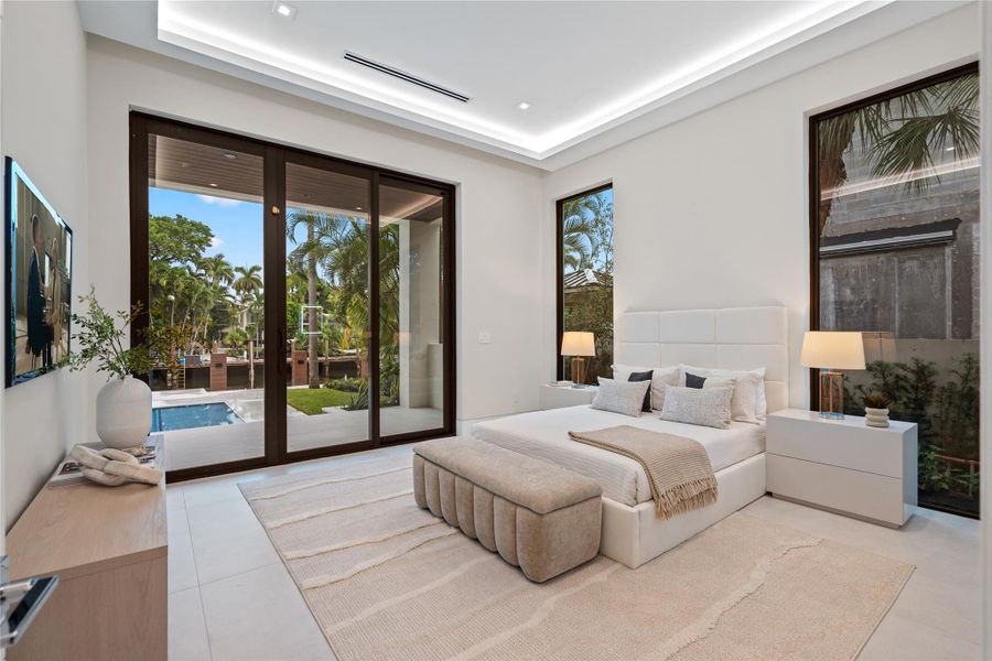 Guest bedroom with poolside views, direct outdoor access, and modern design with floor-to-ceiling windows. Guest bedroom with poolside views, direct outdoor access, and modern design with floor-to-ceiling windows.
