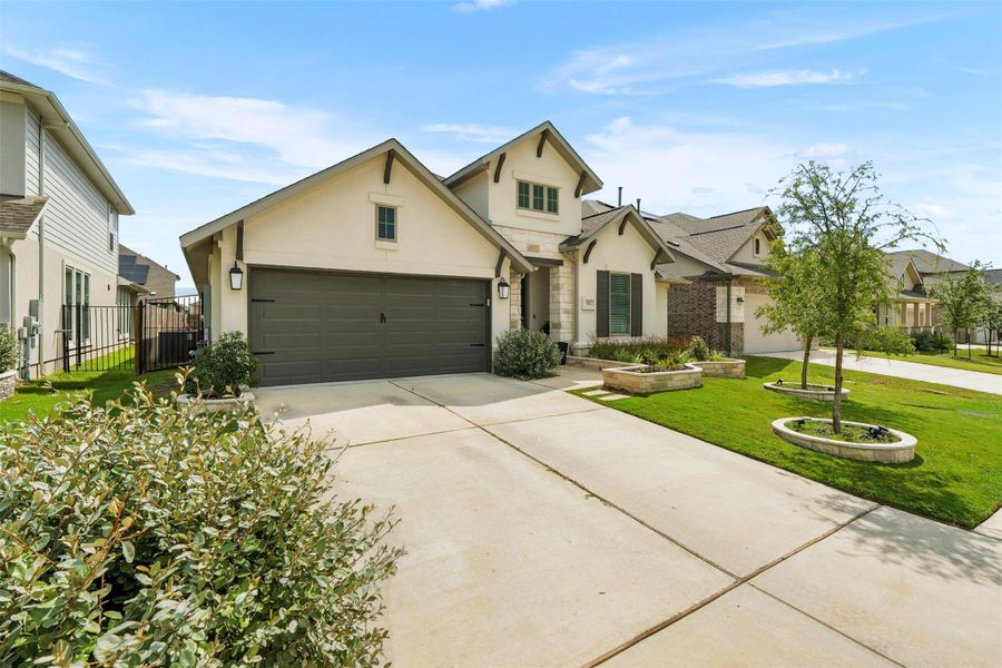 Front exterior of a new home in Santa Rita Ranch 50', Liberty Hill, TX, highlighting curb appeal (Image 18). Front exterior of a new home in Santa Rita Ranch 50', Liberty Hill, TX, highlighting curb appeal (Image 18).