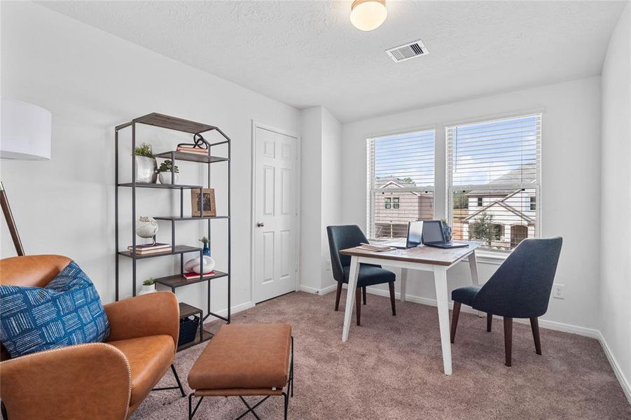 Secondary bedroom is featured here as an office. You are welcomed into this space with plush carpet, neutral paint, lighting, large windows with privacy blinds and ample sized closet space.