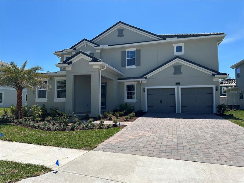 Front exterior of a new home in , Windermere, FL, highlighting curb appeal (Image 1). Front exterior of a new home in , Windermere, FL, highlighting curb appeal (Image 1).