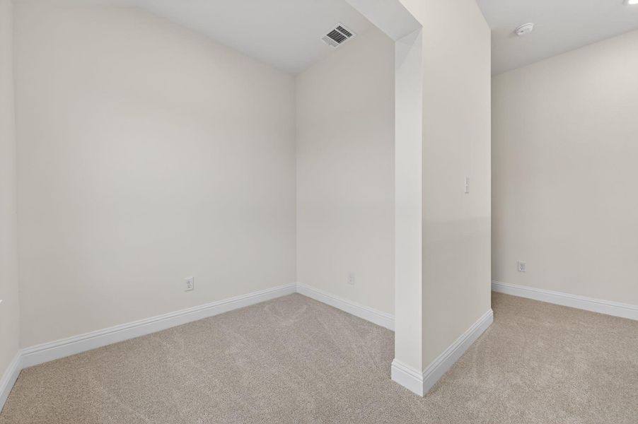 Unfurnished room with baseboards and light colored carpet