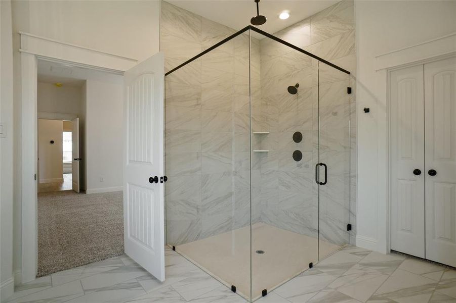 Bathroom with walk in shower and tile flooring