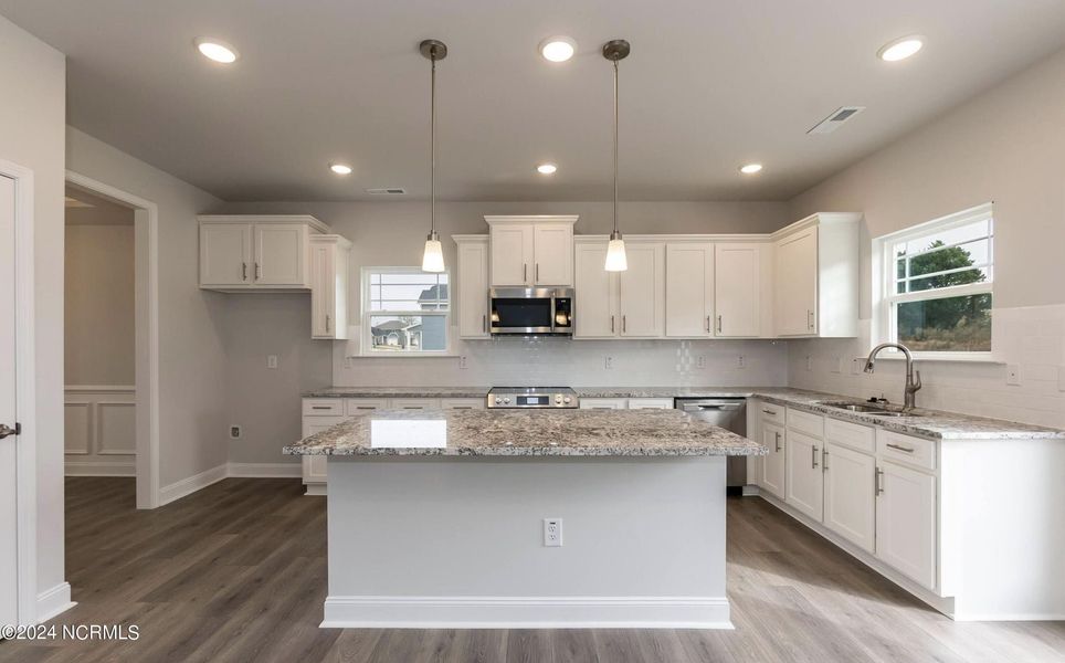 Furnished interior in a model home at Palmetto Creek in Bolivia (Image 8).