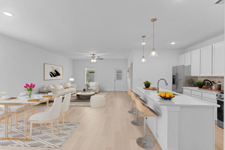 Beautiful new home with ceiling fans, pendant lighting above the huge eat in working station island and so much more!