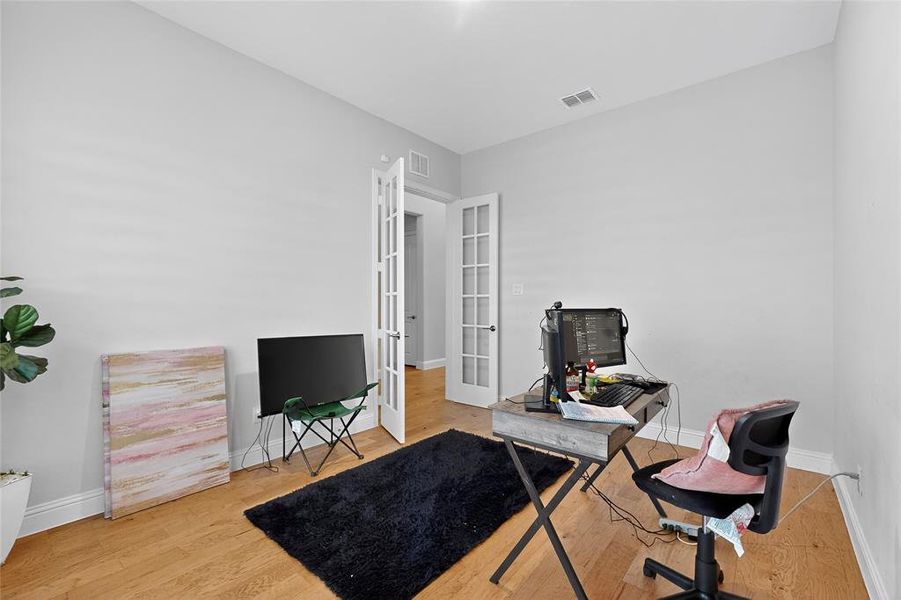Office featuring light wood-type flooring and french doors