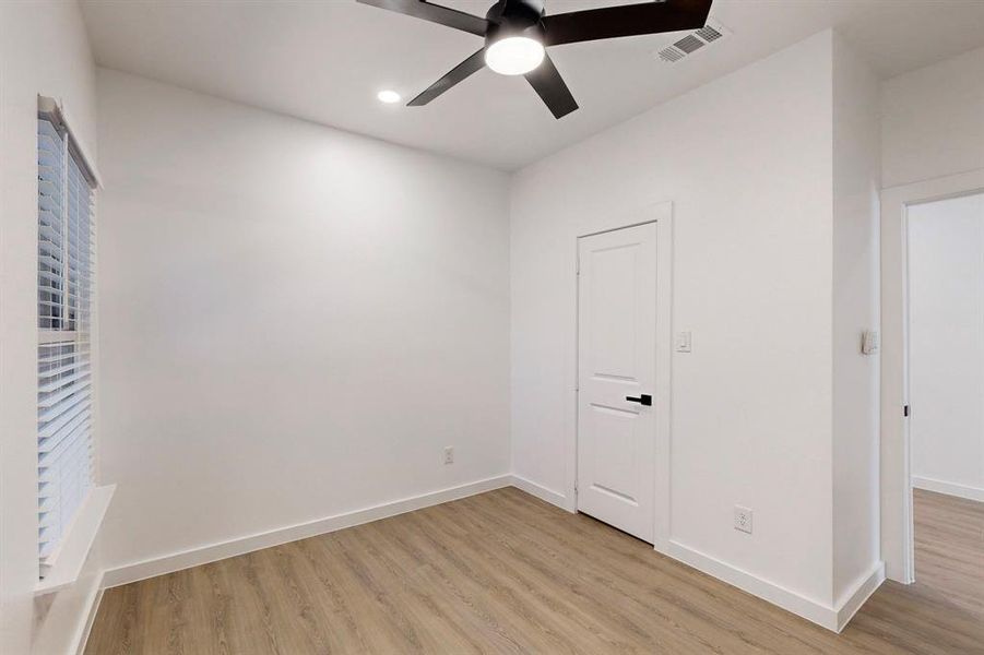 Unfurnished bedroom with ceiling fan and light hardwood / wood-style floors