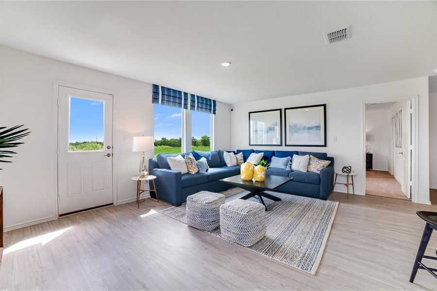Living area featuring light wood-style floors and recessed lighting Living area featuring light wood-style floors and recessed lighting