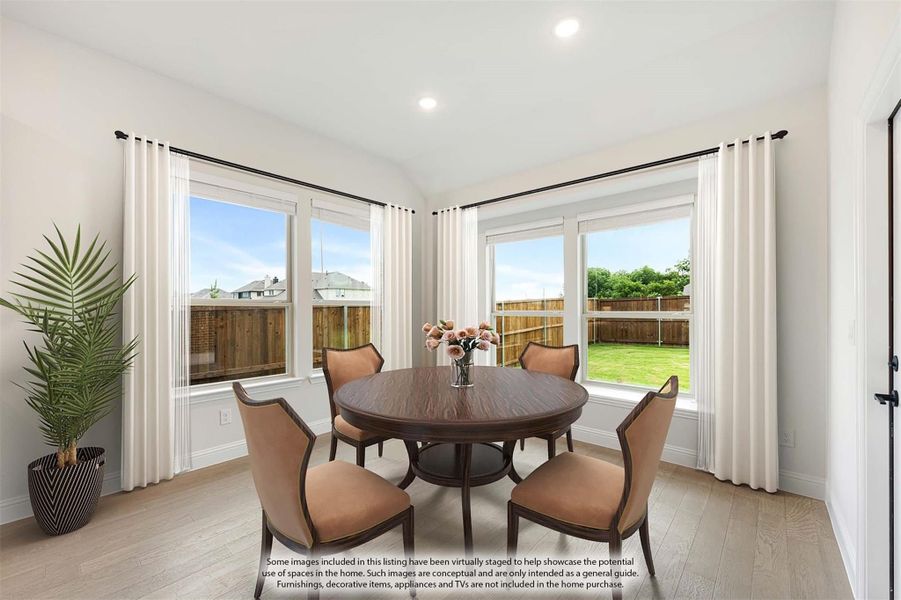 Bright dining area with round wood table, four chairs, and large windows overlooking a backyard Bright dining area with round wood table, four chairs, and large windows overlooking a backyard