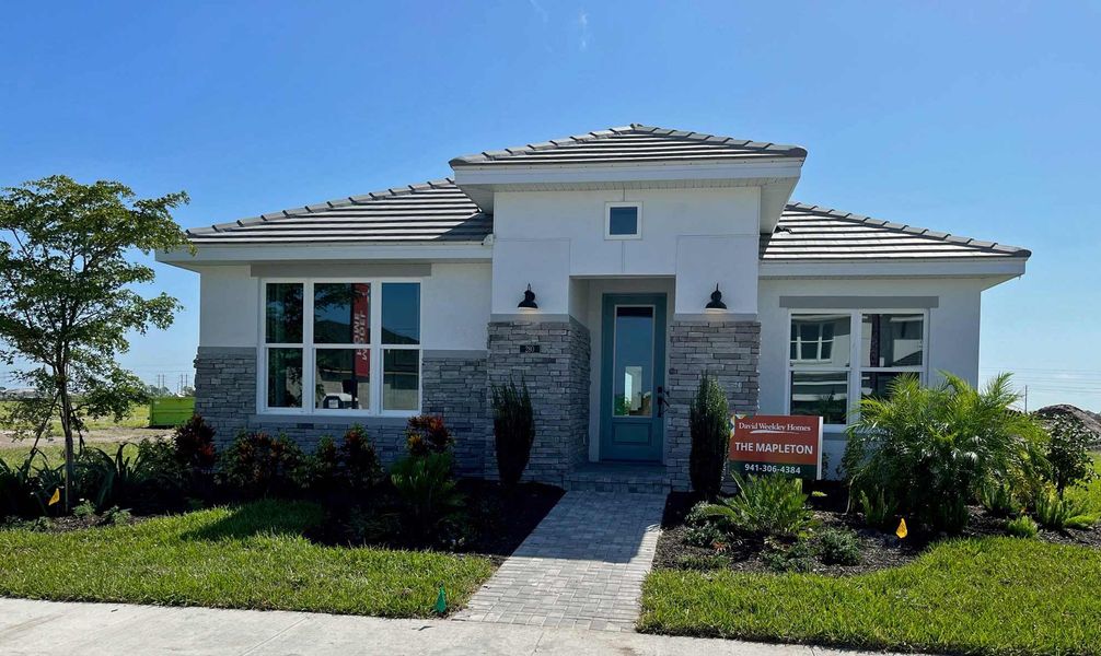 Representative exterior photo of a completed home built from the The Mapleton by David Weekley Homes in Vistera of Venice – Cottage Series, Nokomis, FL (Image 2). Representative exterior photo of a completed home built from the The Mapleton by David Weekley Homes in Vistera of Venice – Cottage Series, Nokomis, FL (Image 2).