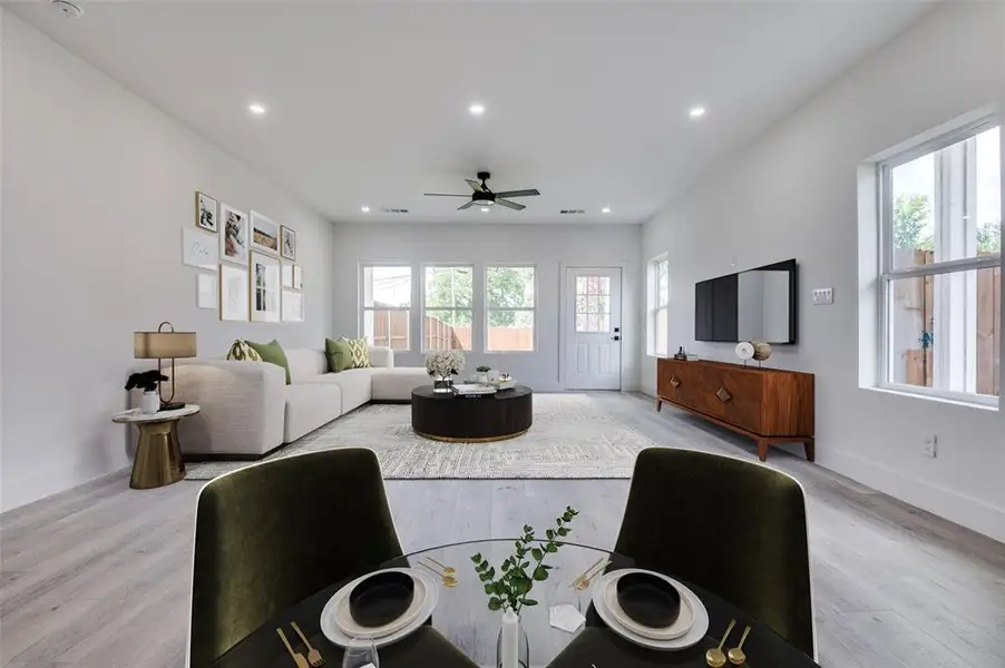 Living room featuring light wood-style flooring, recessed lighting, and ceiling fan Living room featuring light wood-style flooring, recessed lighting, and ceiling fan