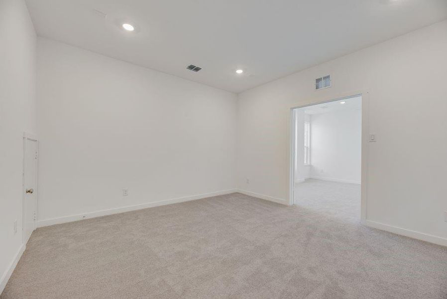 Empty room featuring light carpet and recessed lighting