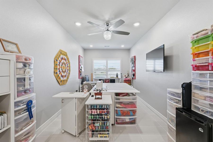 Spacious room featuring light gray walls, recessed lighting, a ceiling fan, and large format tile flooring