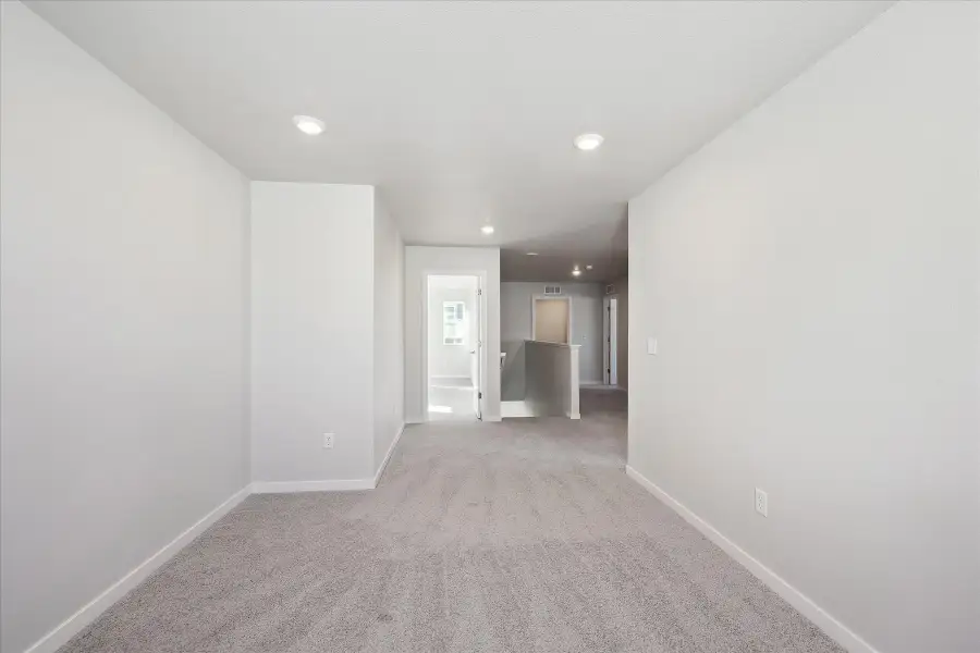 A hallway with white walls.