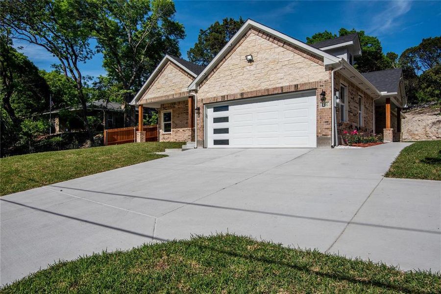 View of front of house featuring a front yard and a garage