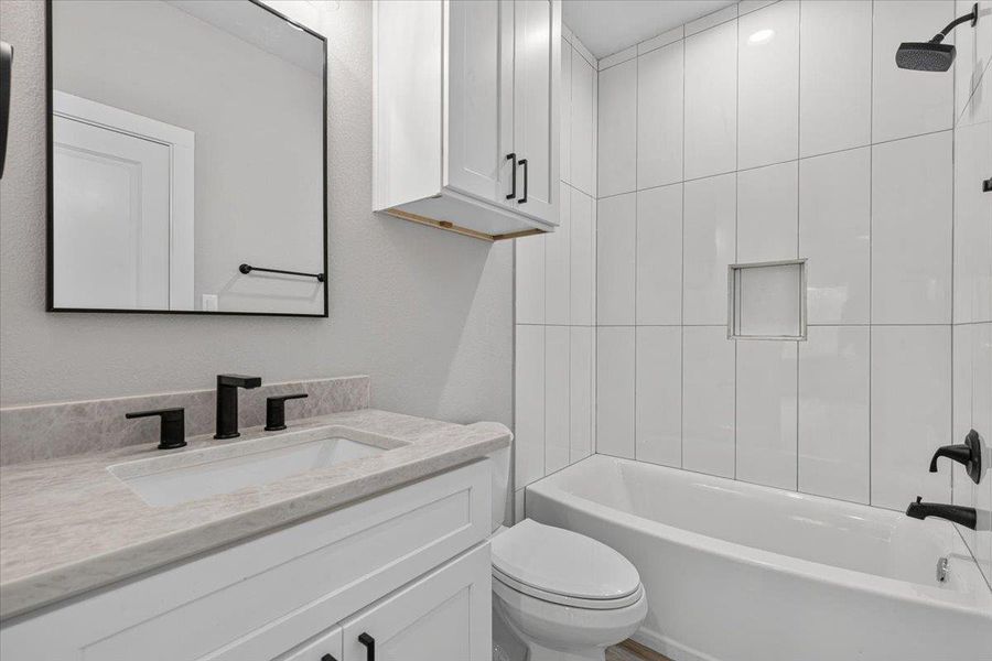 A well-appointed bathroom featuring a clean vanity with a stylish mirror and a pristine bathtub. A well-appointed bathroom featuring a clean vanity with a stylish mirror and a pristine bathtub.