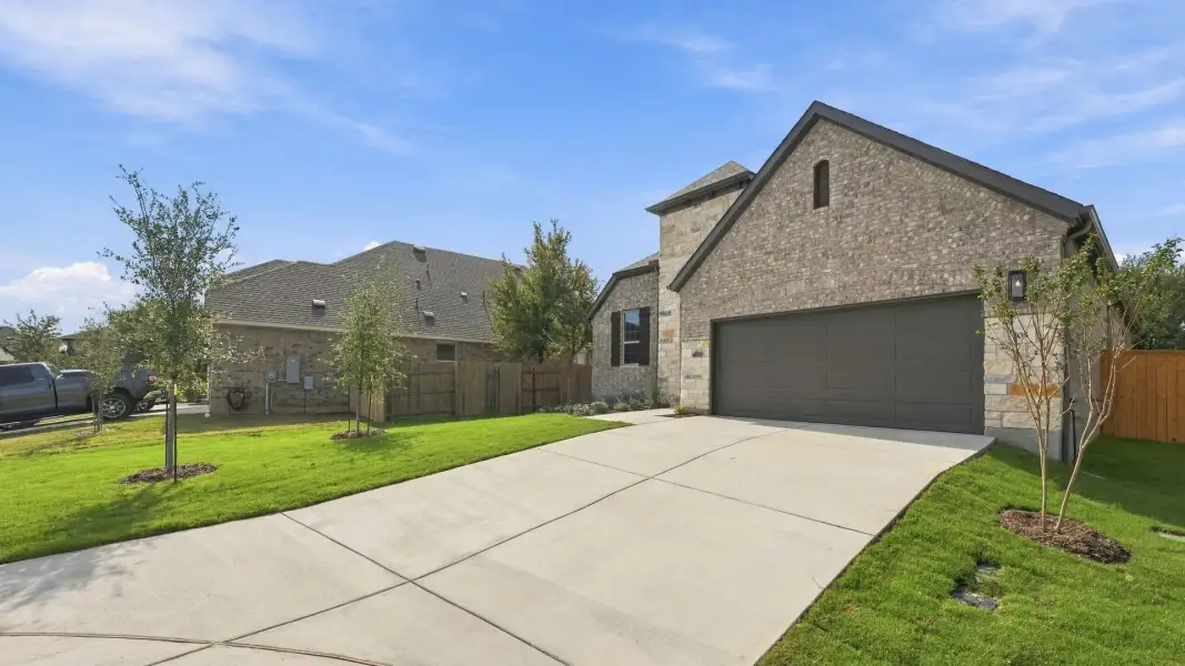 Front exterior of a new home in Oaks at San Gabriel, Georgetown, TX, highlighting curb appeal (Image 21).