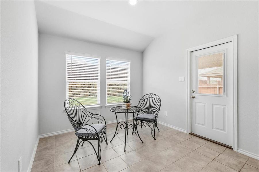 Dining area near kitchen with entry to patio-staged