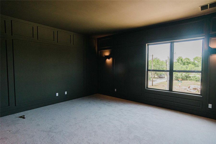 Empty room with a decorative wall and light colored carpet