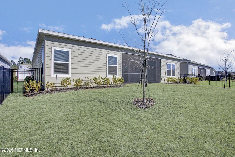 Exterior details and patio area of a home in Tributary: Lakeview at Tributary 60's, Yulee (Image 23).