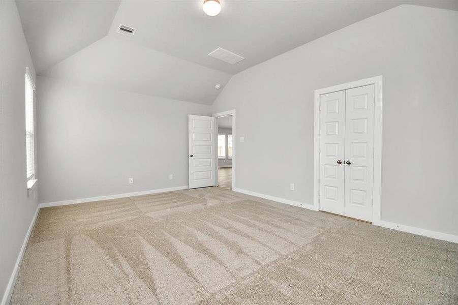 Unwind in style in this remarkable primary suite after a long day! Revel in the luxury of plush carpet, warm paint tones, soaring ceilings, and expansive windows. Sample photo of completed home with similar floor plan. Actual colors and selections may vary.