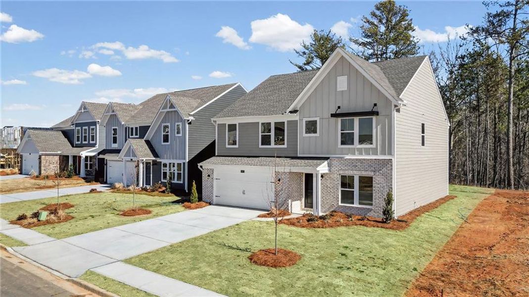 Front exterior of a new home in Twin Lakes, Hoschton, GA, highlighting curb appeal (Image 1). Front exterior of a new home in Twin Lakes, Hoschton, GA, highlighting curb appeal (Image 1).