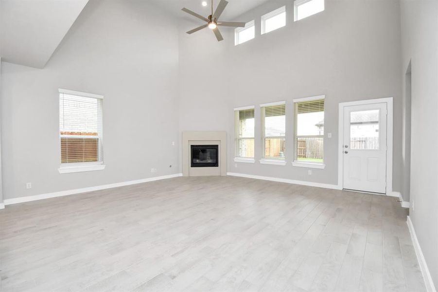 Another view of the spacious family room. Sample photo of completed home with similar floor plan. Actual colors and selections may vary.