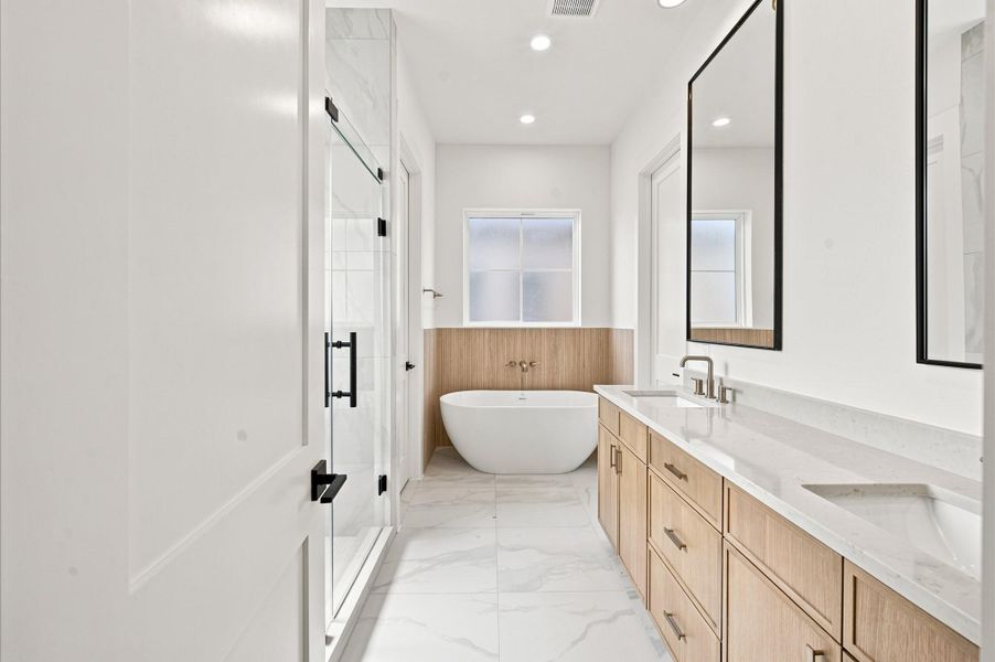 Soaking tub and walk-in shower are featured in the primary bathroom. Soaking tub and walk-in shower are featured in the primary bathroom.