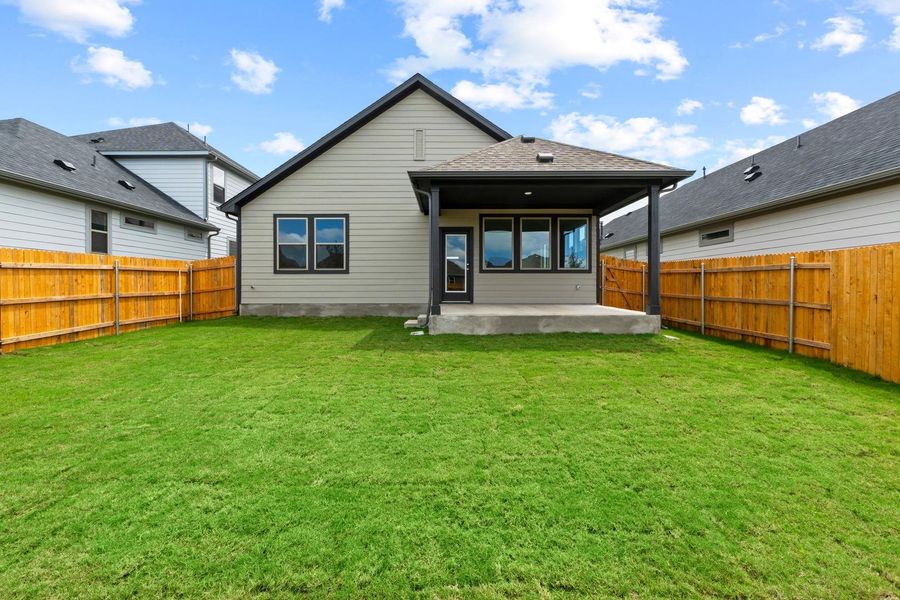 A well-maintained lawn provides a verdant backdrop for the covered patio, perfect for outdoor enjoyment. A well-maintained lawn provides a verdant backdrop for the covered patio, perfect for outdoor enjoyment.