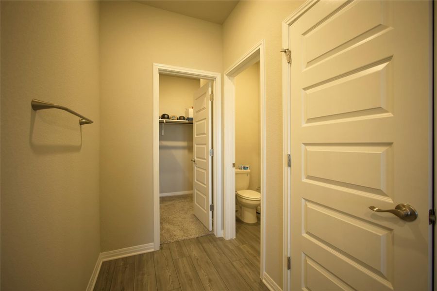 Hall featuring dark wood-style floors and baseboards Hall featuring dark wood-style floors and baseboards
