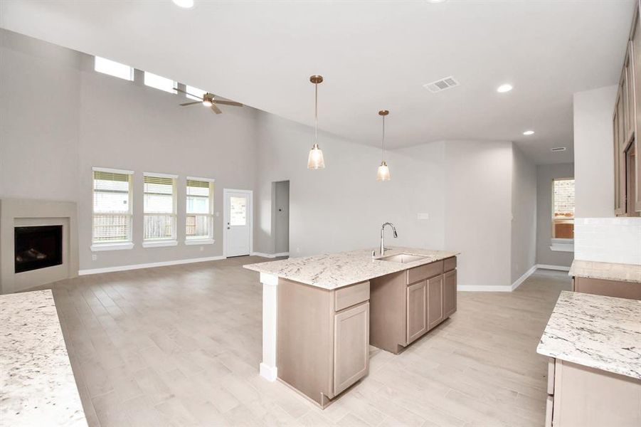 All of this overlooks your expansive family room, creating a perfect space for culinary delights and family gatherings. Sample photo of completed home with similar floor plan. Actual colors and selections may vary.