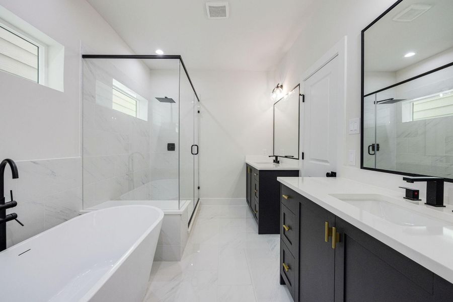 Spa-inspired primary bathroom with freestanding soaking tub Spa-inspired primary bathroom with freestanding soaking tub