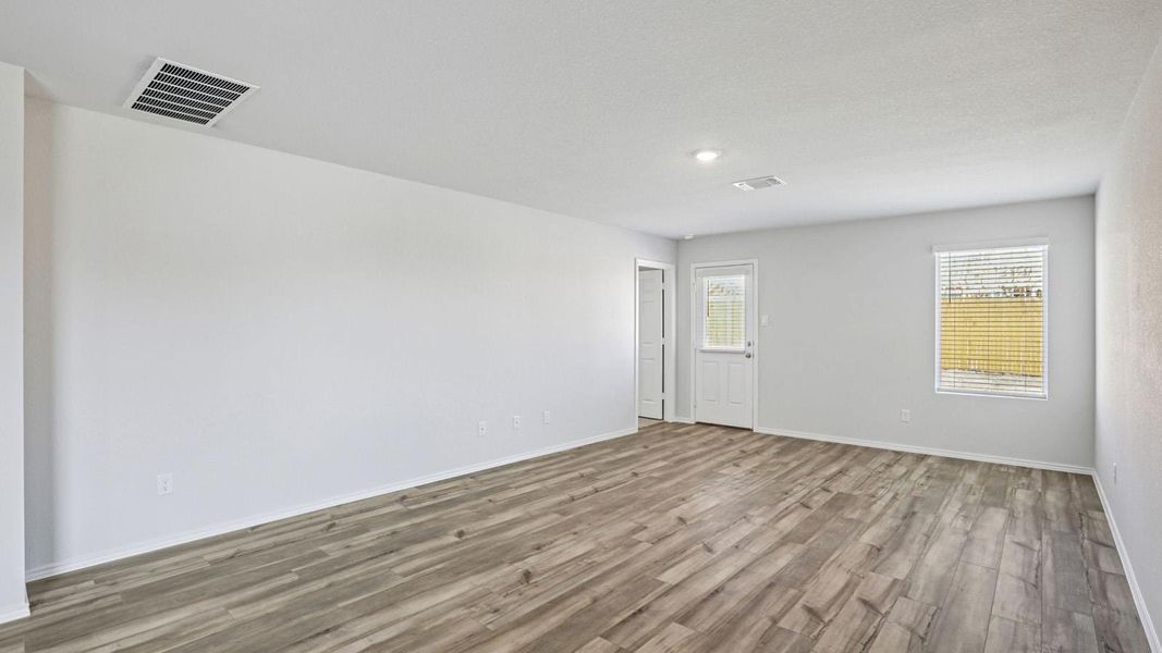 Empty room featuring wood finished floors and baseboards