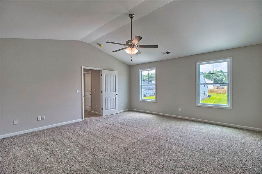 This expansive bedroom offers a tranquil retreat w