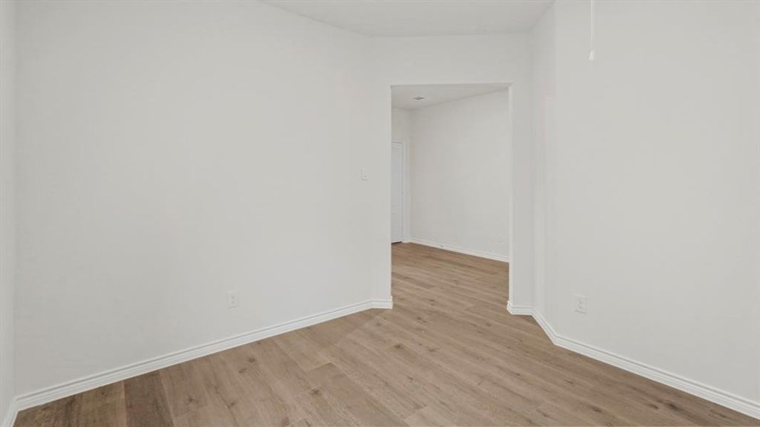 Empty room with light wood-type flooring and baseboards Empty room with light wood-type flooring and baseboards