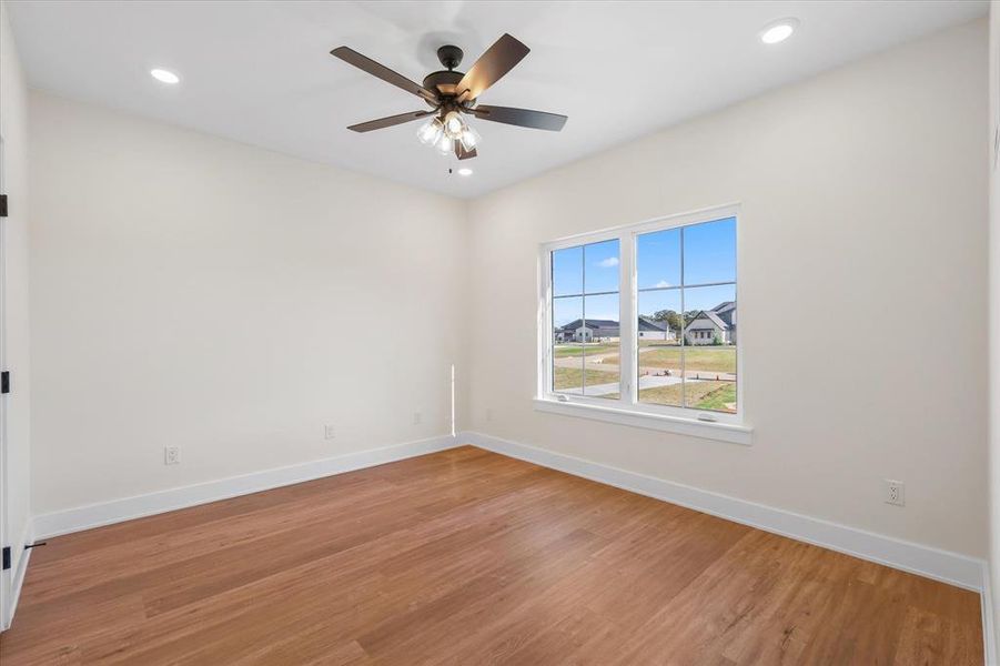 Unfurnished room with light wood-type flooring, ceiling fan, and recessed lighting