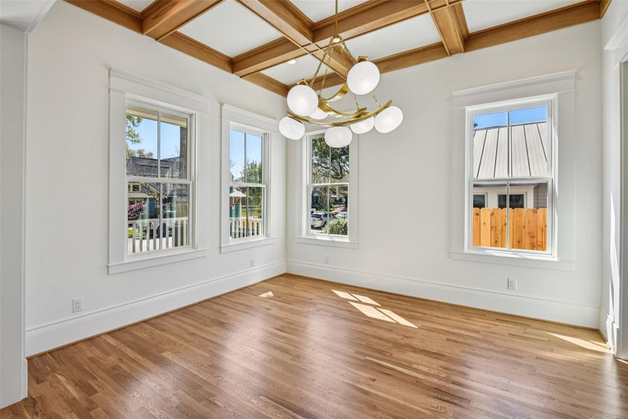 The dining room is a show-stopper, featuring traditional boxed ceilings amidst a more modern, yet highly original globe chandelier. The dining room is a show-stopper, featuring traditional boxed ceilings amidst a more modern, yet highly original globe chandelier.