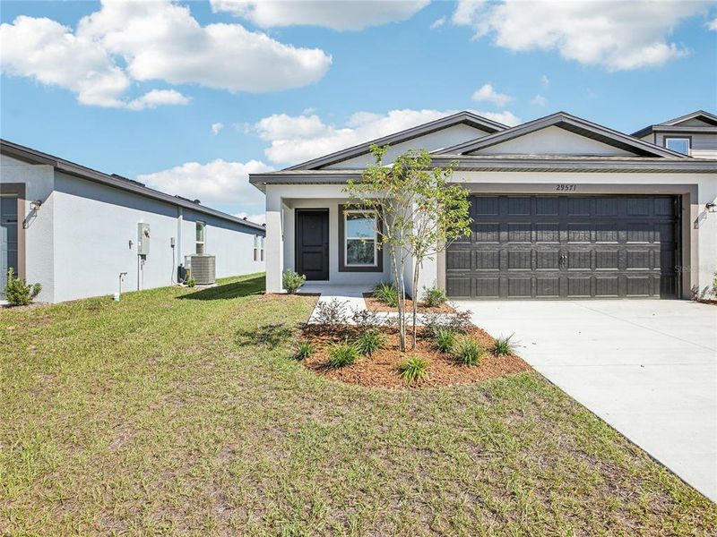 Front exterior of a new home in Trilby Crossing, Brooksville, FL, highlighting curb appeal (Image 2).